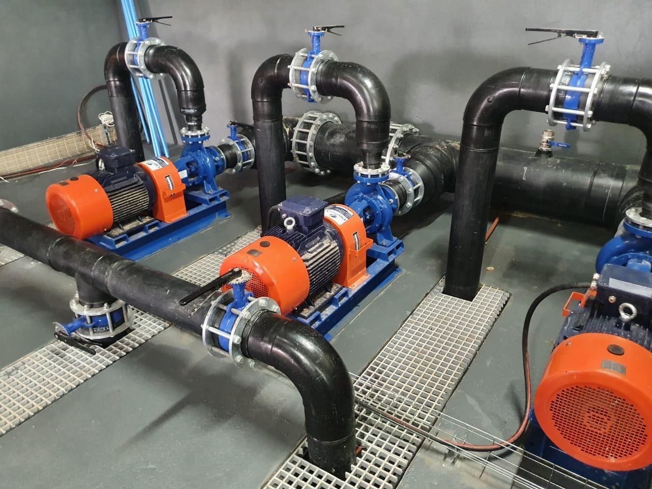 Pumping equipment with blue motors, valves and interconnected pipework